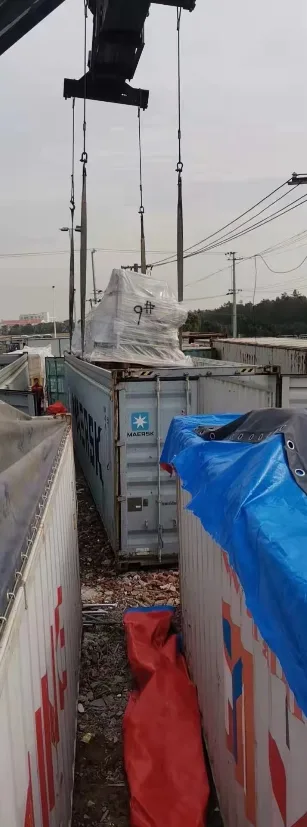 Cargo being lifted between containers
